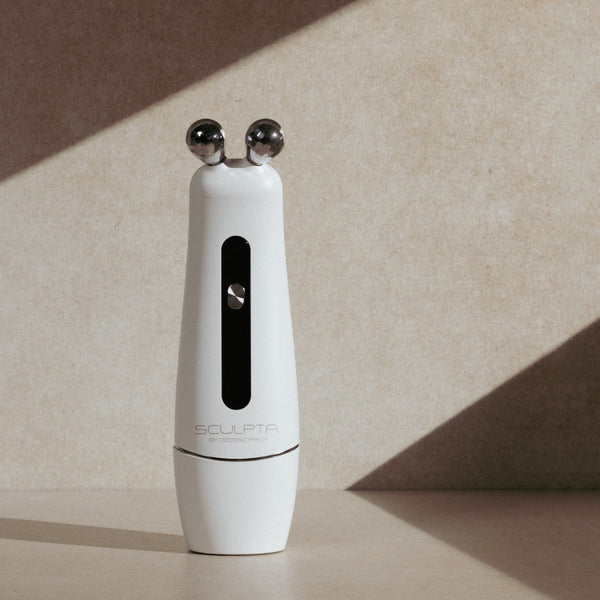 Sculpta by Déesse PRO handheld facial device on neutral surface